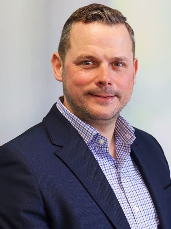A professional headshot of Stuart Norris.