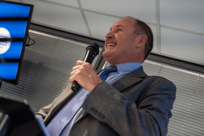 Malcolm Basker giving a speech at the Excellence Awards 2025.