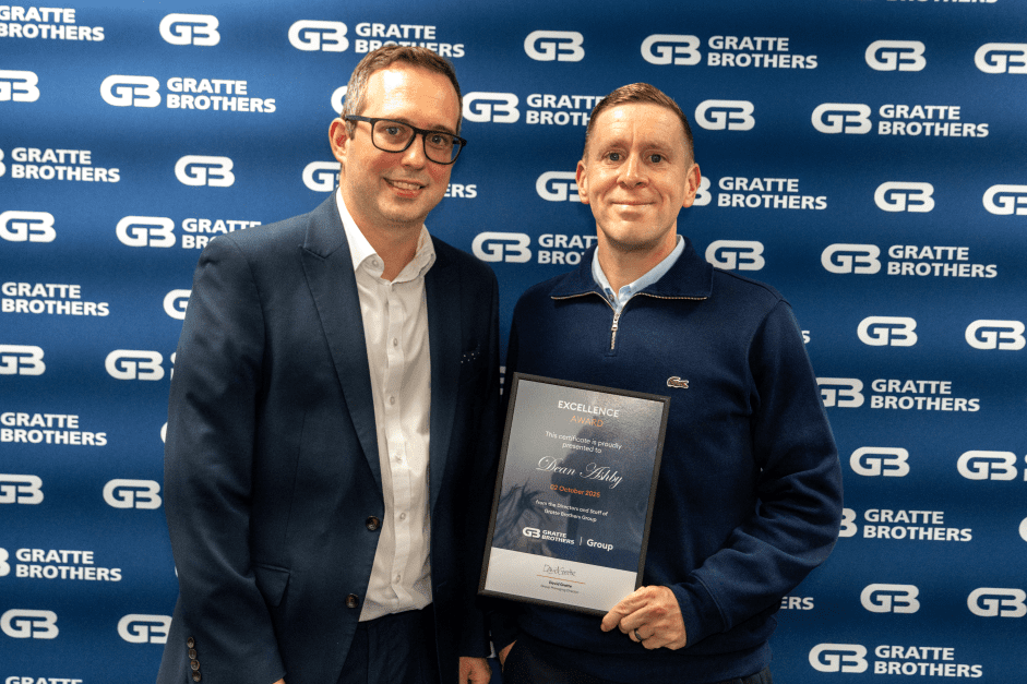 Dean Ashby receiving his award from David Gratte at the Excellence Awards 2025.