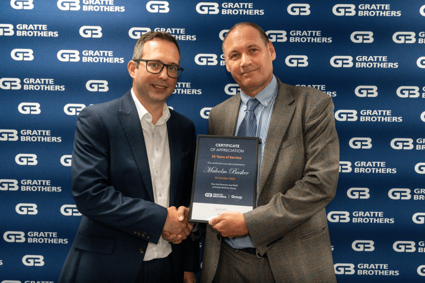 Malcolm basker receiving his award from David Gratte at the Excellence Awards, 2025.