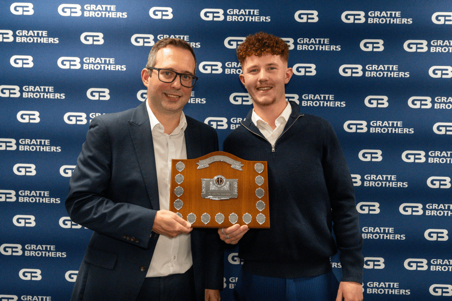 Kian Mahoney receving his trophy from David Gratte at the Excellence Awards 2025.